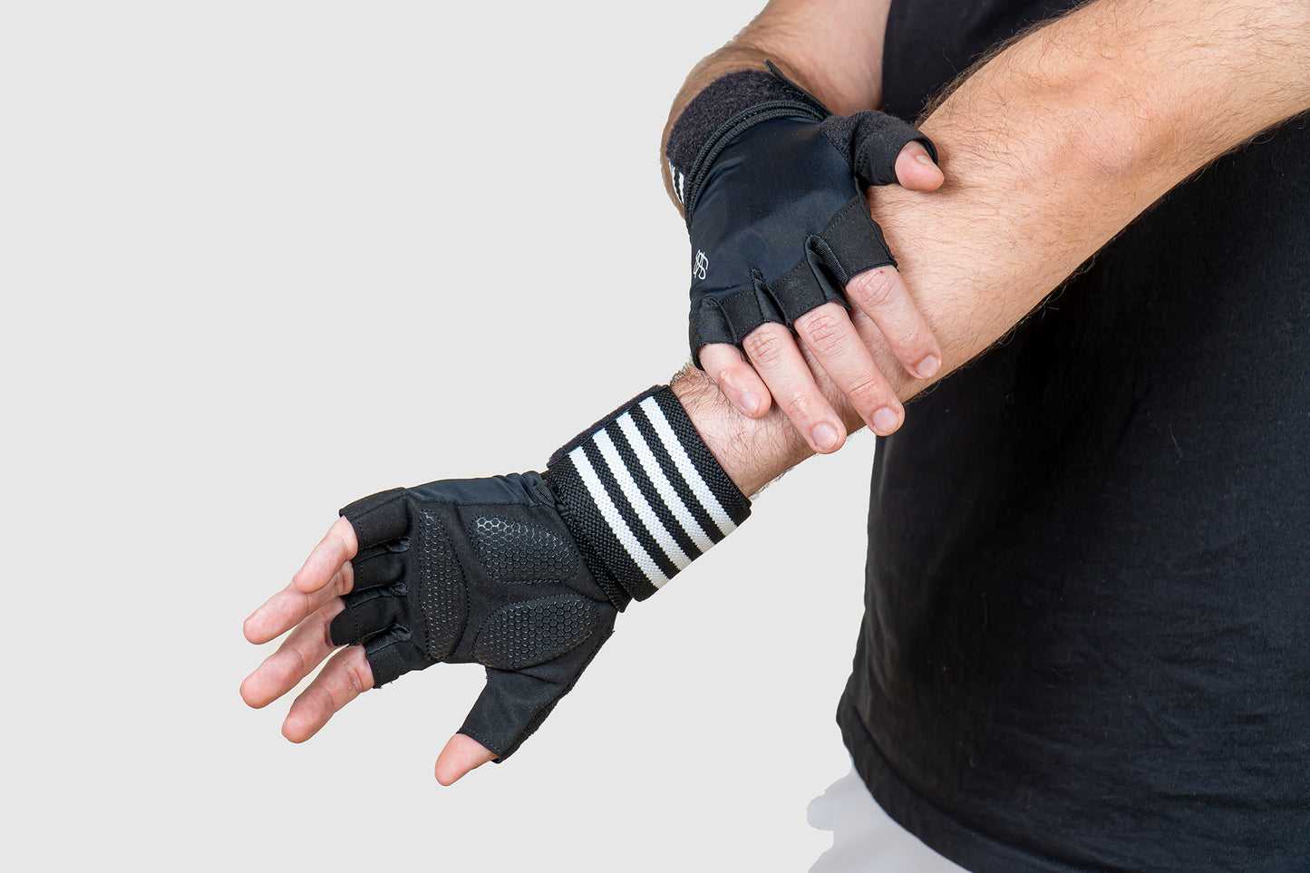 men stretching while wearing gym weightlifting gloves with wrist support.