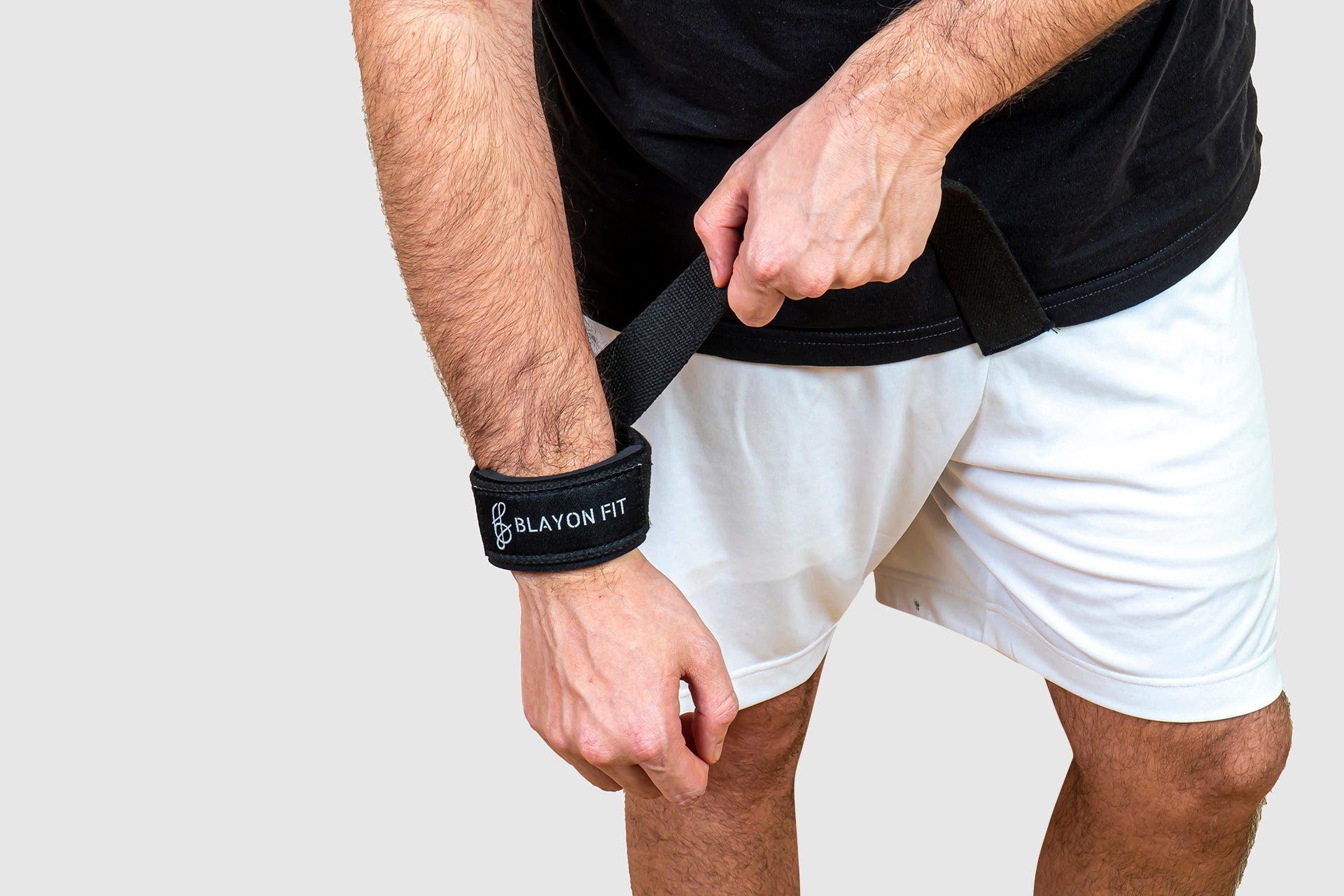 man using the weightlifting wrist strap to increase his weights on the deadlift exercise. 