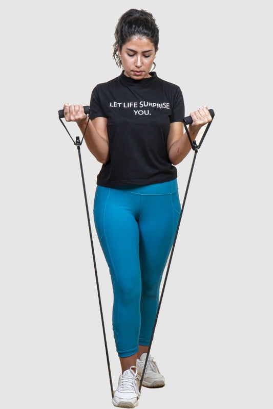 woman exercising her arms  with resistant tube and band.