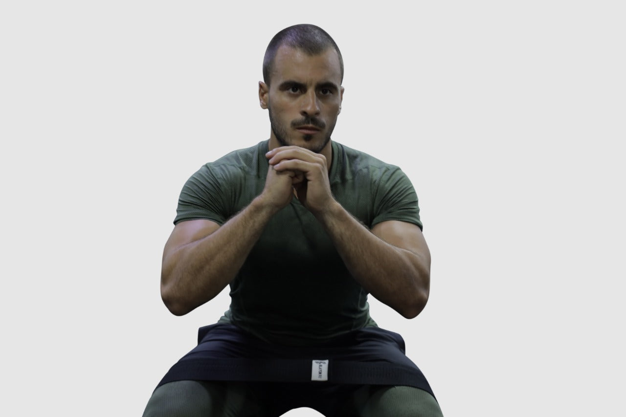 man using black light fabric resistant bands for  home workout 